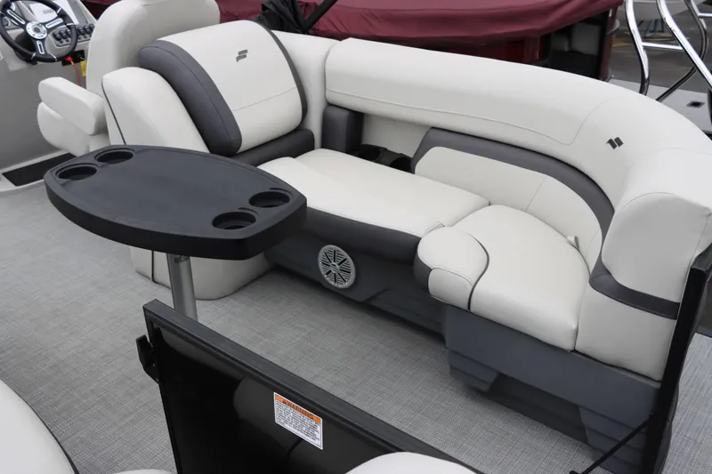 Slide: The Image of 2024 Starcraft EXS 3 boat interior with plush seating and a black table. - 16