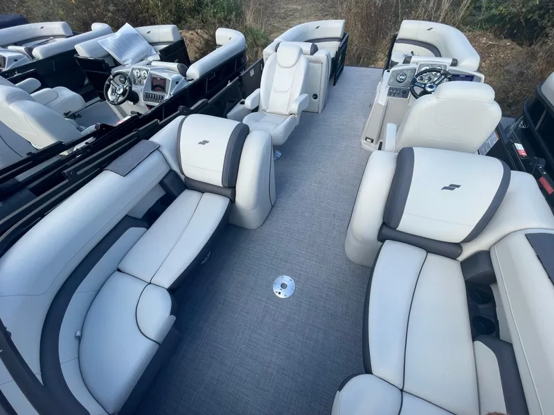 Slide: The Image of 2024 Starcraft EXS 3 pontoon boat interior with luxurious seating and modern dashboard. - 18