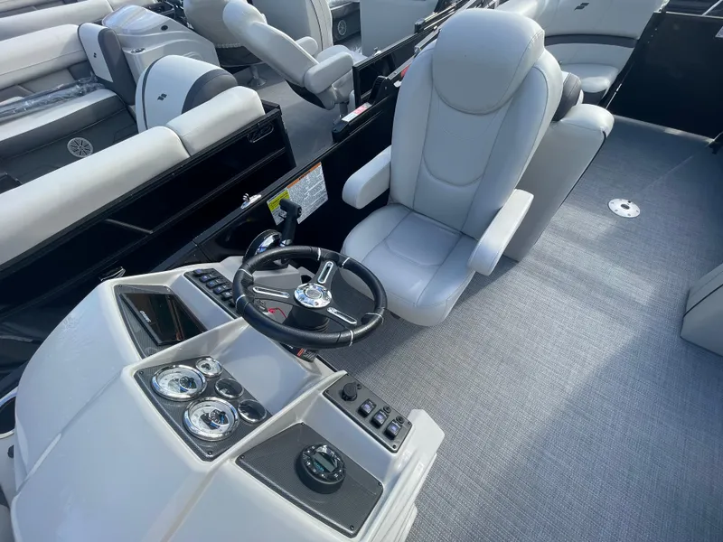 Slide: The Image of 2024 Starcraft EXS 3 boat interior with captain's chair and control panel. - 23