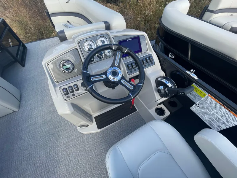Slide: The Image of 2024 Starcraft EXS 3 boat dashboard with steering wheel and control panel. - 24