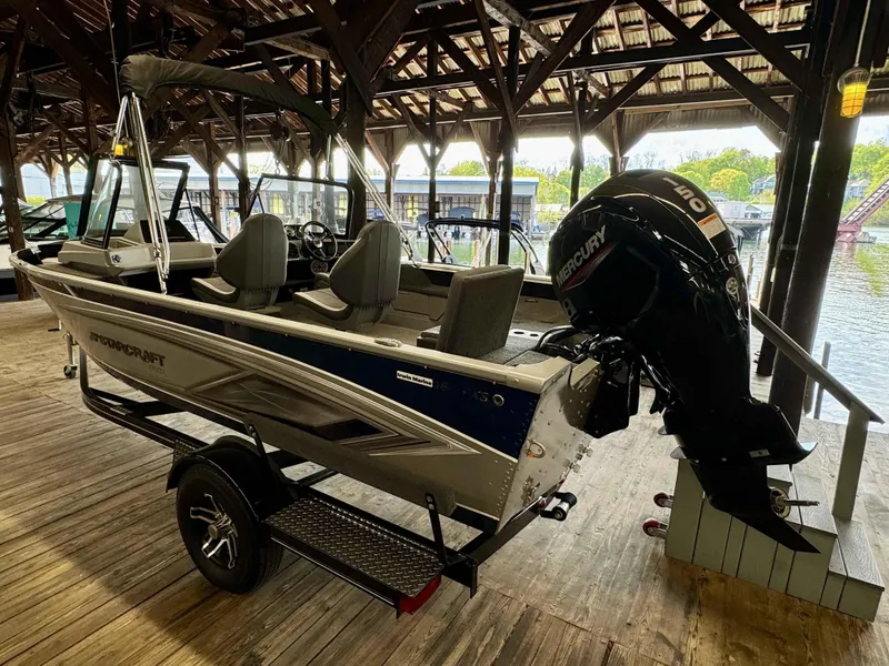 Slide: The Image of 2023 Starcraft Delta 188 FXS boat with Mercury outboard motor in a covered dock. - 16