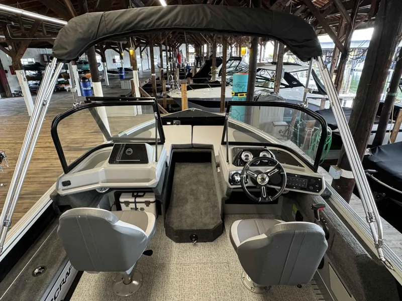 Slide: The Image of 2023 Starcraft Delta 188 FXS boat interior with dual seats and steering console. - 19