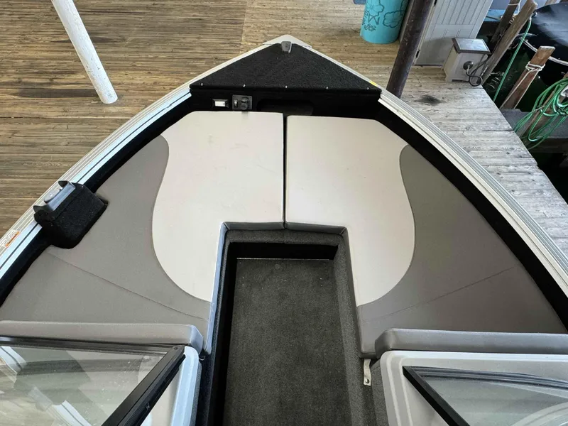 Slide: The Image of 2023 Starcraft Delta 188 FXS boat interior with cushioned seating and storage compartments. - 20