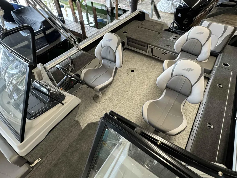 Slide: The Image of 2023 Starcraft Delta 188 FXS boat interior with gray seating and steering console. - 8