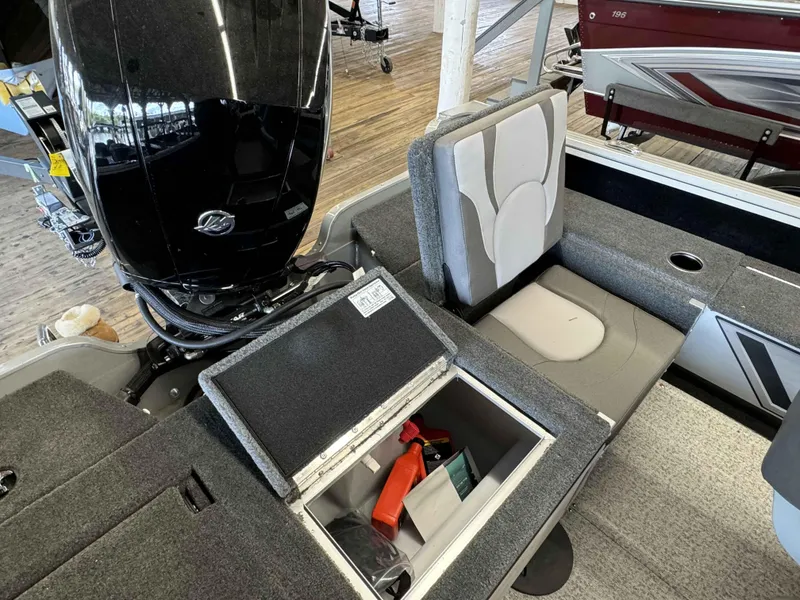 Slide: The Image of 2023 Starcraft Delta 188 FXS boat interior with storage compartment and outboard motor. - 9