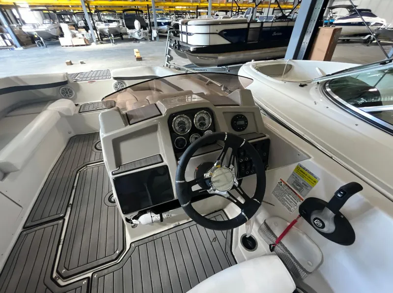 Slide: The Image of 2023 Starcraft SVX 191 OB boat interior with steering wheel and control panel. - 5