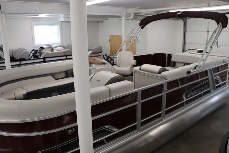 Slide: The Image of 2023 Starcraft EX 22C pontoon boat in showroom, featuring spacious seating and sleek design. - 3