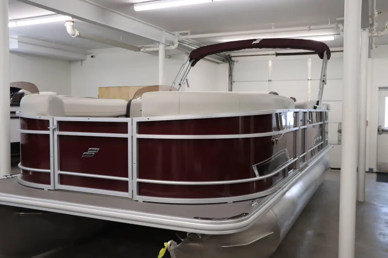 Slide: The Image of 2023 Starcraft EX 22C pontoon boat in indoor storage. - 4