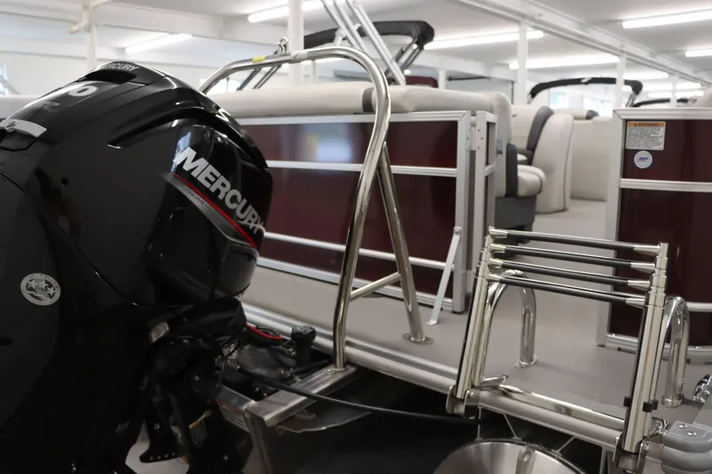 Slide: The Image of 2023 Starcraft EX 22C pontoon boat with Mercury outboard motor in showroom. - 6