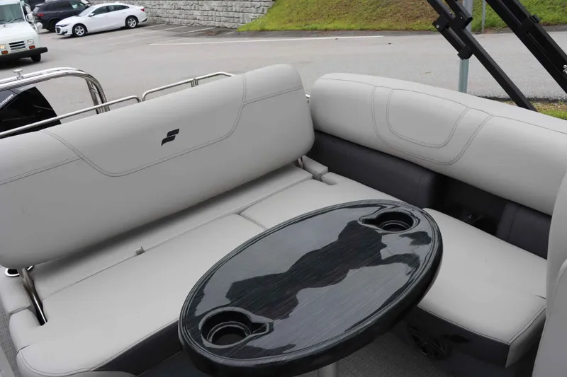 Slide: The Image of 2023 Starcraft CX 23Q DH boat interior with sleek seating and oval table. - 14