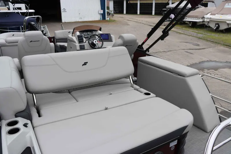 Slide: The Image of 2023 Starcraft CX 23Q DH boat interior with plush seating and modern dashboard. - 16