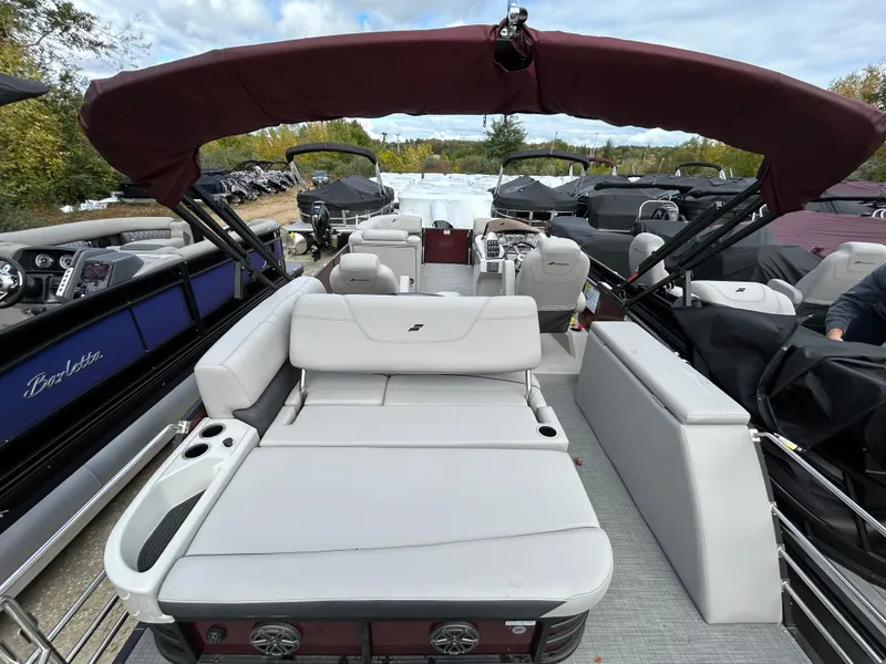 Slide: The Image of 2023 Starcraft CX 23Q DH pontoon boat with maroon canopy and spacious seating. - 21