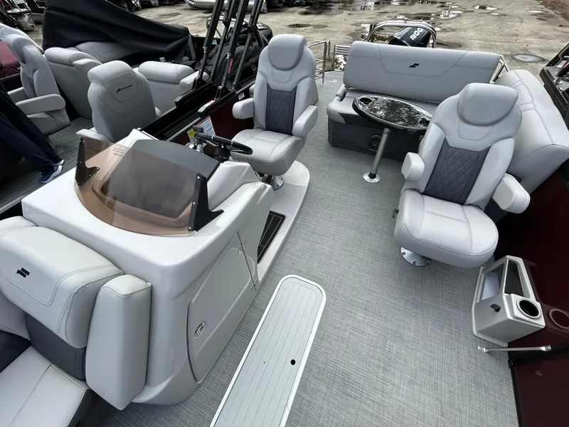 Slide: The Image of 2023 Starcraft CX 23Q DH pontoon boat interior with luxurious seating and helm. - 23