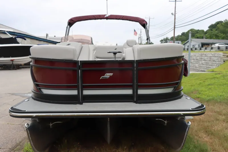 Slide: The Image of 2023 Starcraft CX 23Q DH pontoon boat, rear view, parked on grass. - 4