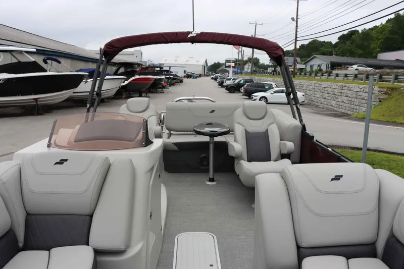 Slide: The Image of 2023 Starcraft CX 23Q DH pontoon boat with luxurious seating at a marina. - 7