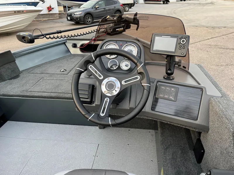 Slide: The Image of 2023 Starcraft Storm 176 SC boat dashboard with steering wheel and navigation system. - 2