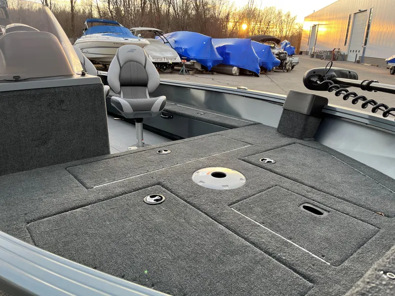 Slide: The Image of 2023 Starcraft Storm 176 SC fishing boat interior with gray carpet and seating. - 4
