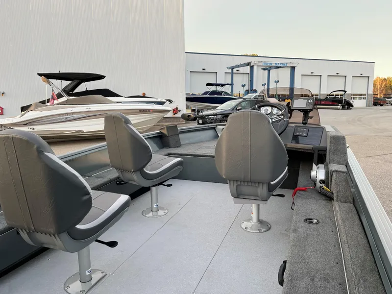 Slide: The Image of 2023 Starcraft Storm 176 SC fishing boat interior with three seats and control panel. - 7