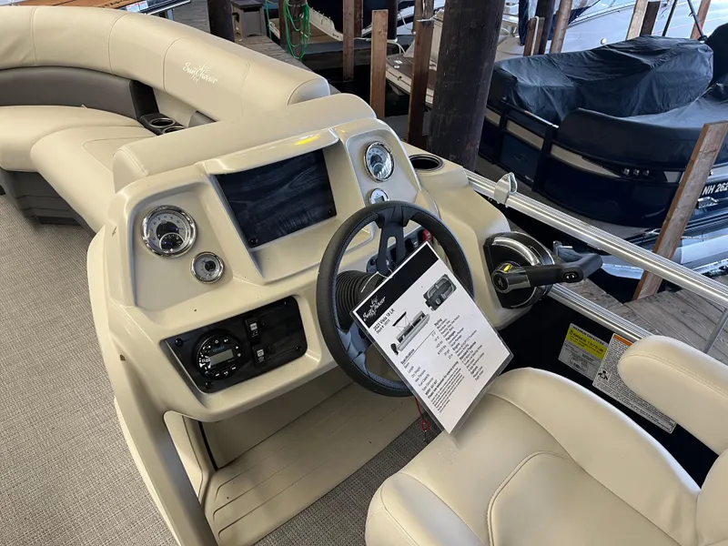 Slide: The Image of 2023 SunChaser VISTA 18LR boat interior with steering console and seating. - 3