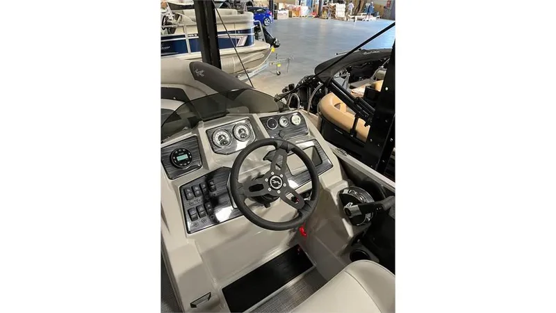 Slide: The Image of 2023 SunChaser Geneva 20CRS boat dashboard with steering wheel and control panel. - 7