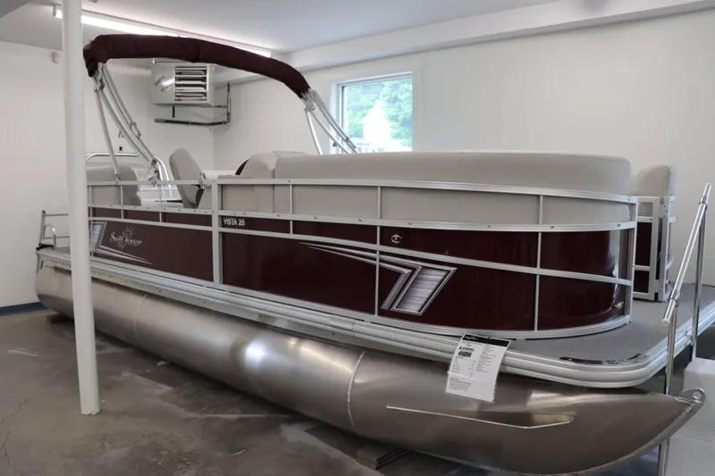 Slide: The Image of 2023 SunChaser VISTA 20LR pontoon boat in showroom. - 2
