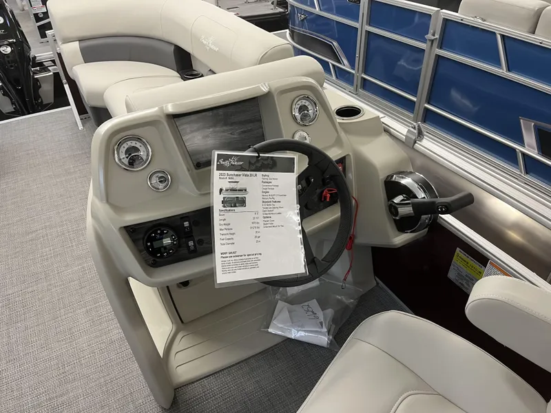 Slide: The Image of 2023 SunChaser VISTA 20LR boat dashboard with steering wheel and control panel. - 4