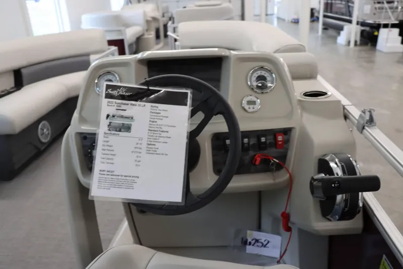 Slide: The Image of 2023 SunChaser VISTA 20LR boat dashboard with steering wheel and control panel. - 5