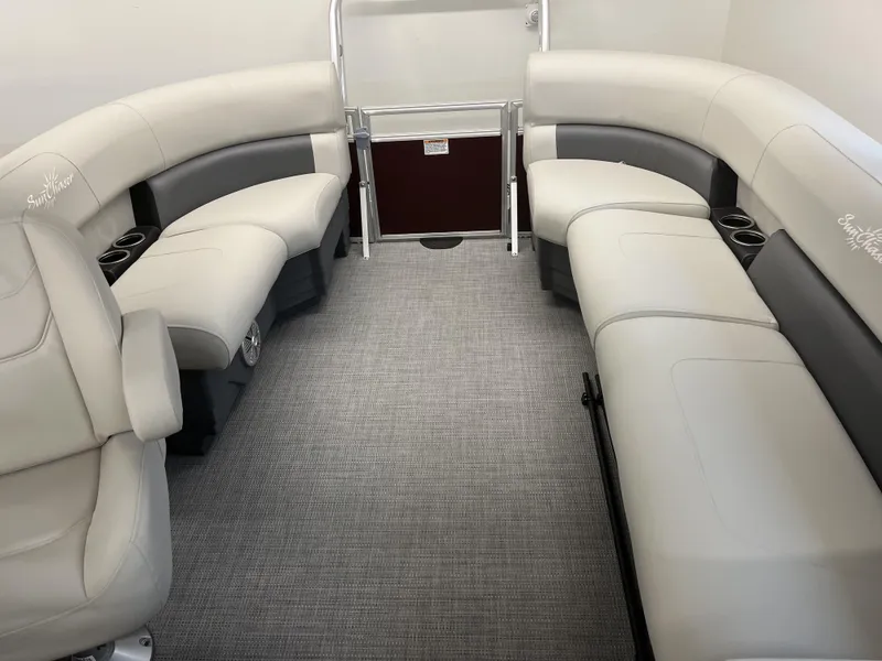 Slide: The Image of 2023 SunChaser VISTA 20LR boat interior with plush seating and cup holders. - 6
