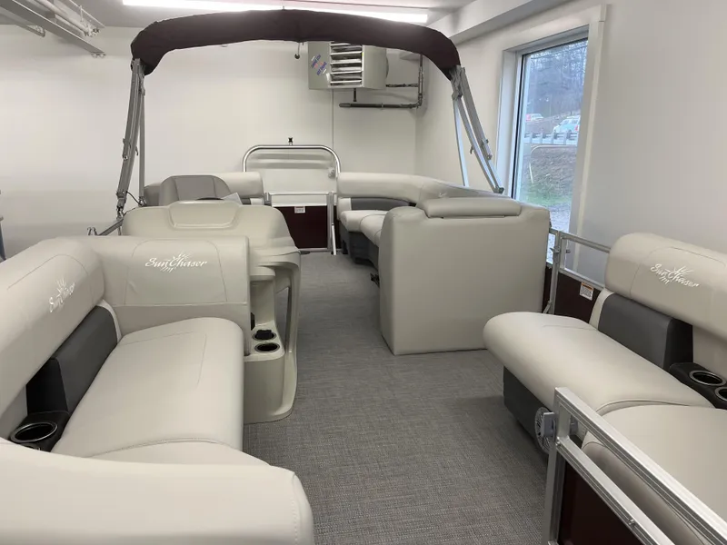 Slide: The Image of 2023 SunChaser VISTA 20LR pontoon boat interior with beige seating and cup holders. - 7