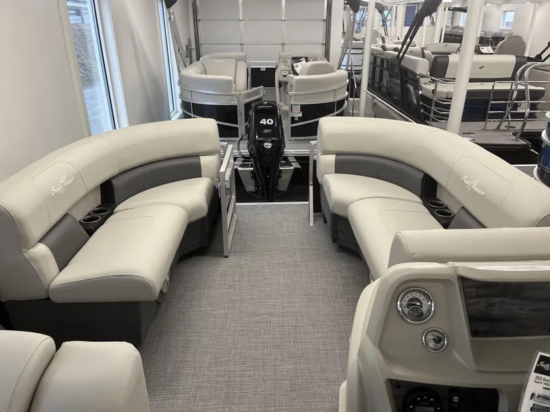 Slide: The Image of 2023 SunChaser VISTA 20LR pontoon boat interior with plush seating and modern dashboard. - 8