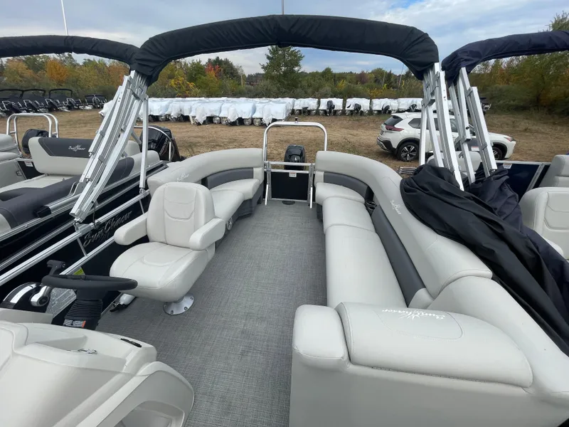 Slide: The Image of 2023 SunChaser VISTA 20LR pontoon boat interior with plush seating and steering console. - 3