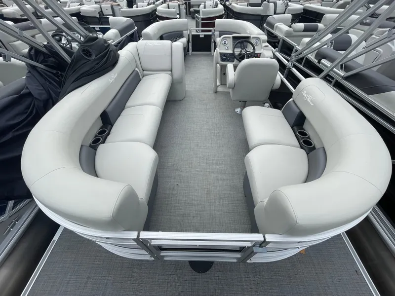 Slide: The Image of 2023 SunChaser VISTA 20LR pontoon boat interior with plush seating and modern dashboard. - 6