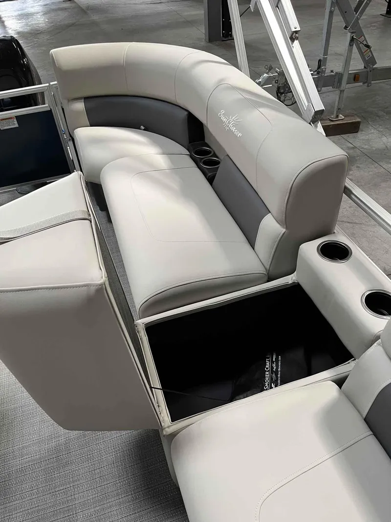 Slide: The Image of 2023 SunChaser VISTA 16LR boat interior with plush seating and cup holders. - 11