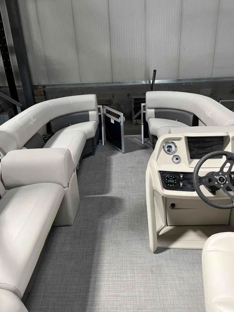 Slide: The Image of 2023 SunChaser VISTA 16LR pontoon boat interior with plush seating and modern dashboard. - 13