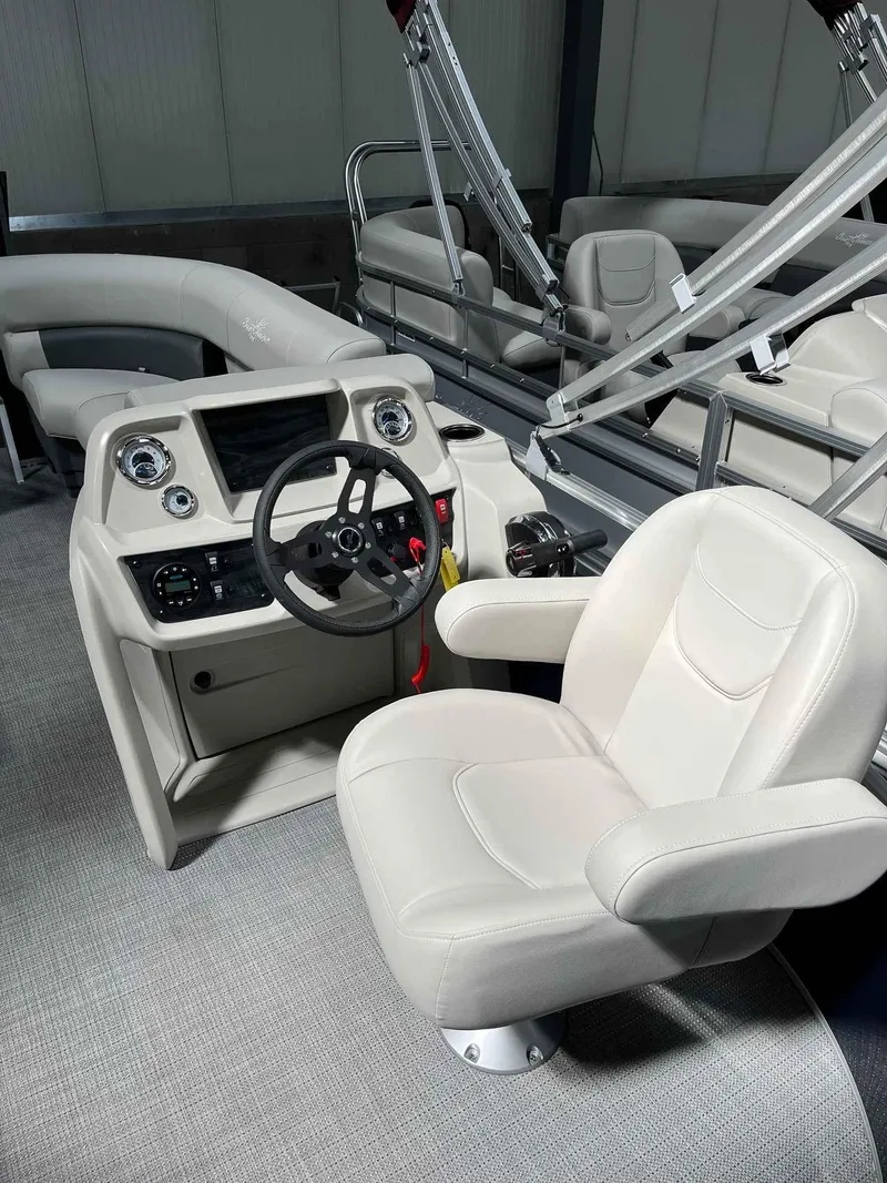 Slide: The Image of 2023 SunChaser VISTA 16LR boat interior with steering console and plush seating. - 14