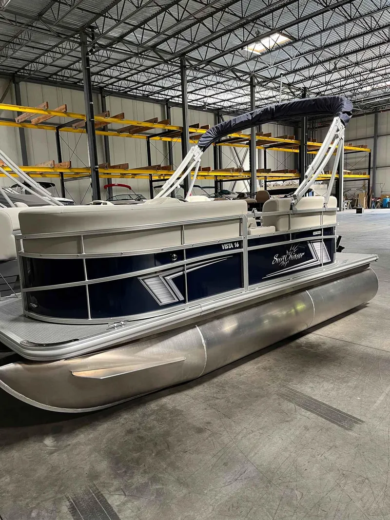 Slide: The Image of 2023 SunChaser VISTA 16LR pontoon boat in warehouse setting. - 5