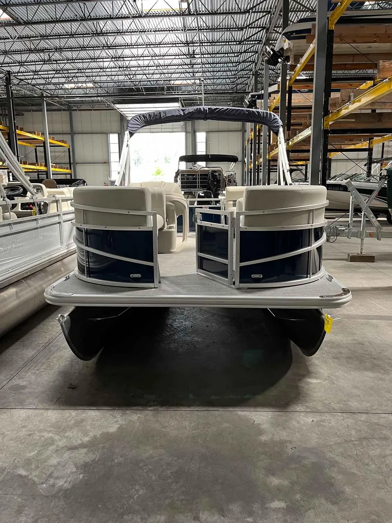 Slide: The Image of 2023 SunChaser VISTA 16LR pontoon boat in a warehouse setting. - 7