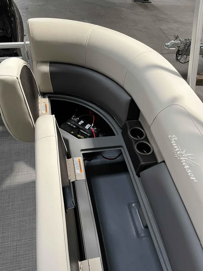 Slide: The Image of 2023 SunChaser VISTA 16LR boat interior with storage compartment and cup holders. - 8
