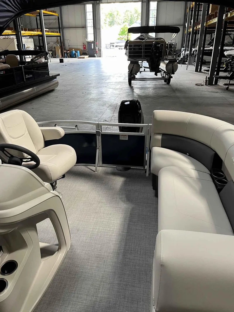 Slide: The Image of 2023 SunChaser VISTA 16LR pontoon boat interior in a storage facility. - 9