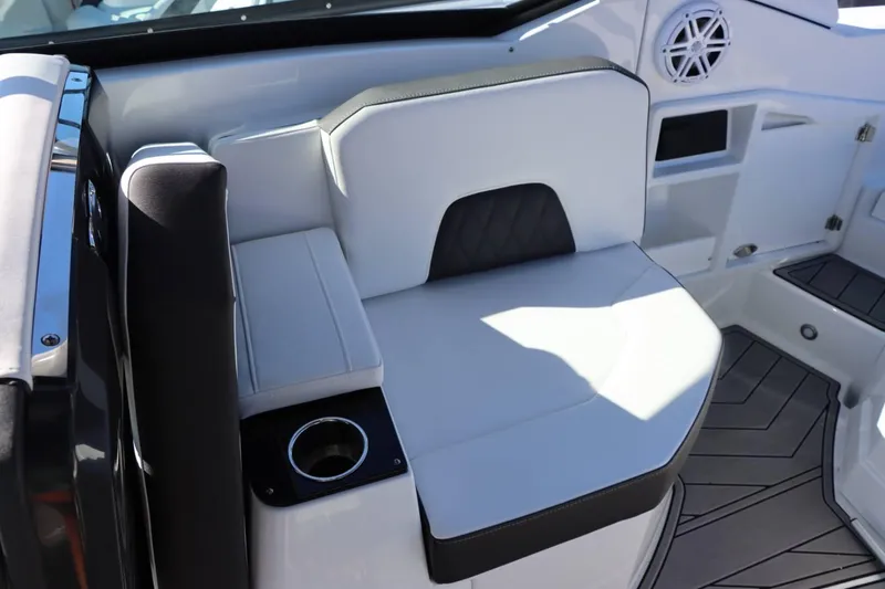Slide: The Image of 2023 Monterey 298SS boat interior seating with cup holder and speaker. - 13