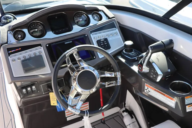 Slide: The Image of 2023 Monterey 298SS boat dashboard with steering wheel, controls, and navigation system. - 20