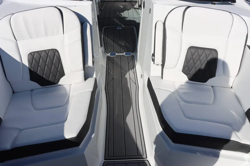 Slide: The Image of 2023 Monterey 298SS boat interior with white and black cushioned seats. - 24