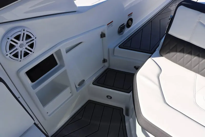 Slide: The Image of Interior of 2023 Monterey 298SS boat with speaker, storage compartments, and cushioned seating. - 28