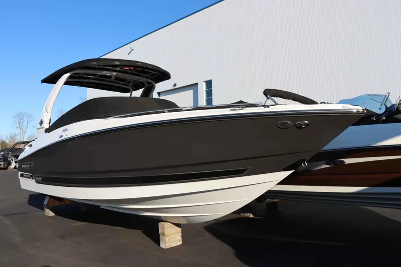 Slide: The Image of 2023 Monterey 298SS boat displayed outdoors on blocks. - 3