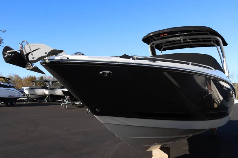 Slide: The Image of 2023 Monterey 298SS boat with sleek black hull, docked outdoors. - 4