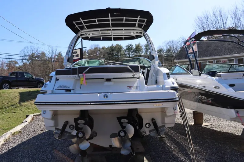 Slide: The Image of 2023 Monterey 298SS boat, rear view, displayed outdoors. - 6