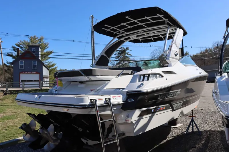 Slide: The Image of 2023 Monterey 298SS boat with black and white exterior, docked near Alton Fire Department. - 7