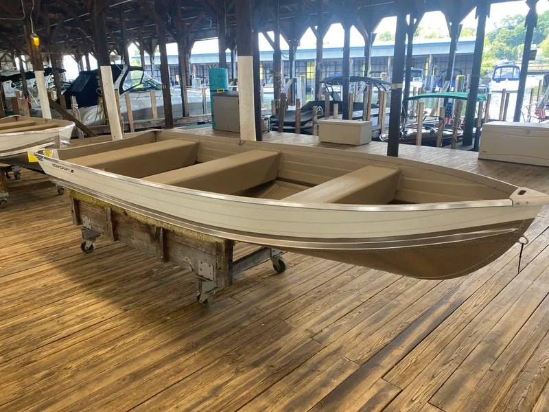 Slide: The Image of 2023 Starcraft 14 SEALITE TS boat displayed in a wooden dock area. - 1