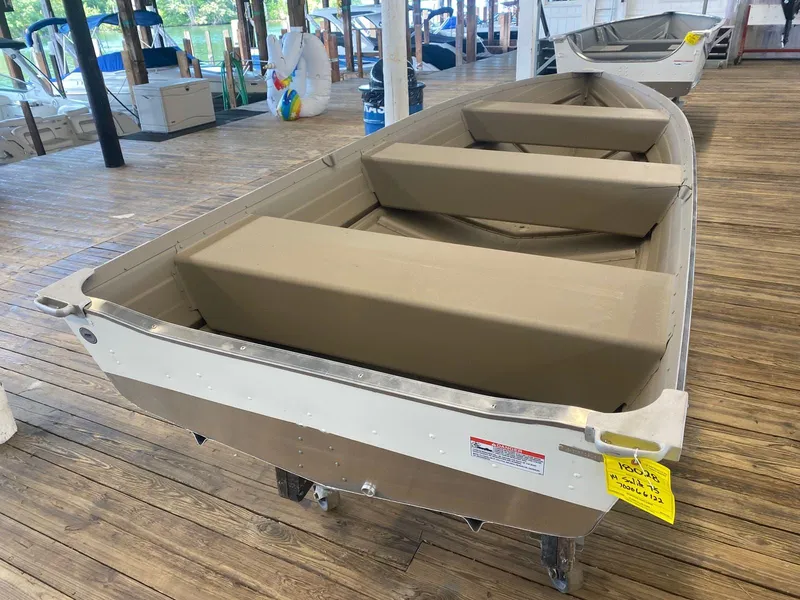 Slide: The Image of 2023 Starcraft 14 SEALITE TS boat on display in a marina. - 2