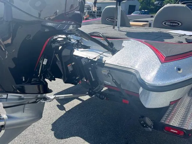 Slide: The Image of 2024 Triton 18 TrX boat rear view with motor and deck. - 4